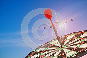 Red darts arrows hit on center of dartboard with sky blue, business goal concept