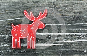 Red deer with snowflakes and snowdrifts