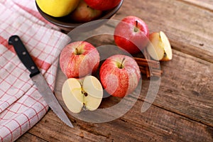 Red delicious  winter Apple with cinnamon sticks on rustic wooden table - close up