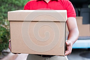 Red Delivery man holding a box package