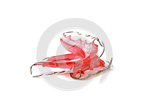 Red dental retainer orthodontia, isolated on white background photo