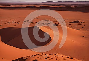 A Red Desert Landscape With Hills In The Background.