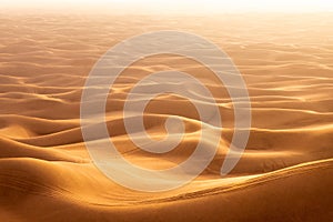 The red deset outside Dubai, with a dune in the foreground and a dunescape extending to the horizon in the background photo