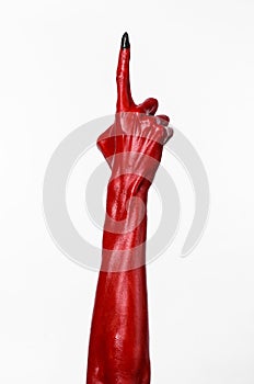 Red Devil's hands with black nails, red hands of Satan, Halloween theme, on a white background, isolated