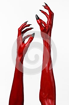 Red Devil's hands with black nails, red hands of Satan, Halloween theme, on a white background, isolated