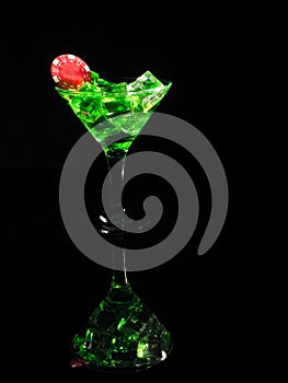 Red dice in a cocktail glass on black background. casino series