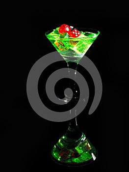 Red dice in a cocktail glass on black background. casino series