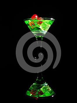 Red dice in a cocktail glass on black background. casino series