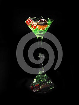 Red dice in a cocktail glass on black background. casino series