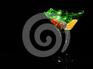 Red dice in a cocktail glass on black background. casino series