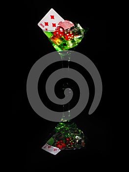 Red dice in a cocktail glass on black background. casino series