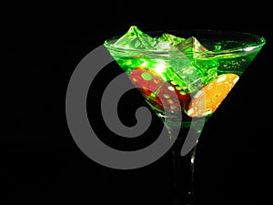 Red dice in a cocktail glass on black background. casino series