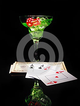 Red dice and a cocktail glass on black background. casino series