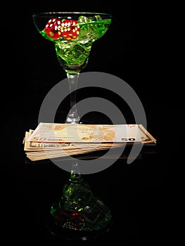 Red dice and a cocktail glass on black background. casino series