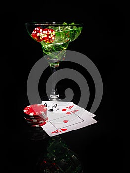 Red dice and a cocktail glass on black background. casino series