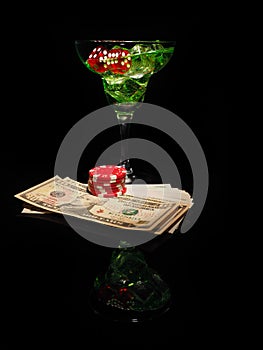 Red dice and a cocktail glass on black background. casino series