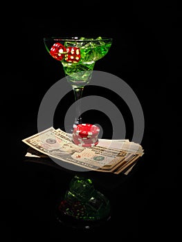 Red dice and a cocktail glass on black background. casino series