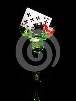 Red dice and a cocktail glass on black background. casino series