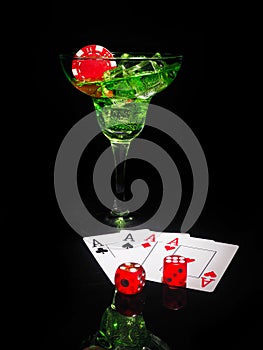 Red dice and a cocktail glass on black background. casino series