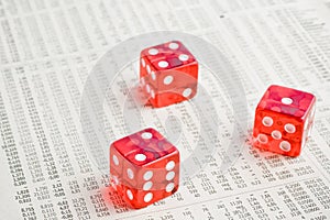 Red dice on the financial newspaper