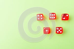 Red dice lying on a green background