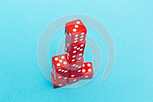 Red dice in the shape of a pyramid, growing from one to six, on a blue background