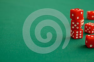 Red dices on green poker gaming table in casino. Concept online gambling. Copy space for text