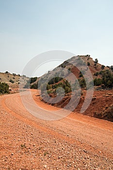 Red dirt and gravel Crooked Creek Road through the Pryor Mountains in Wyoming