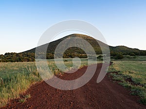 A Red Dirt Road Leading to Capulin Volcano in New Mexico photo