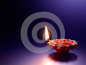 Red diya oil lamp on purple backgroud