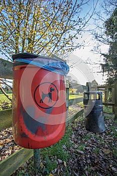 Red dog waste bin. Responsible pet ownership.