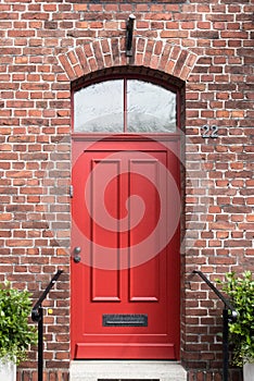 A red door on a brick building in a German village