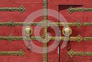 Red door with bronze door knob
