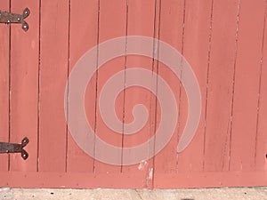 Red door, with black hinges on the left side.