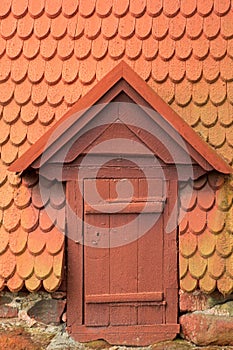 Red door and shingle roof.