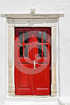 Red door, typical of a house on the island of Myconos, Cyclades, Greece