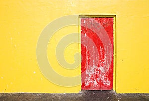 Red door on yellow wall