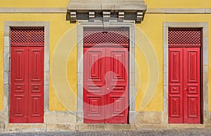 Red doors of an old house in Valenca do Minho