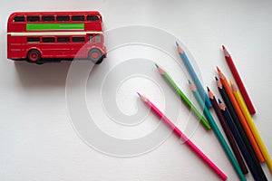 Red, double-Decker bus from London and colored pencils on white isolate...