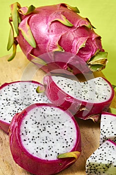 Red dragon fruit Set with appetizing serving on green background. Top view