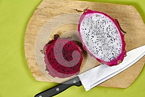 Red dragon fruit Set with appetizing serving on green background. Top view