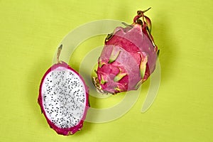 Red dragon fruit Set with appetizing serving on green background. Top view