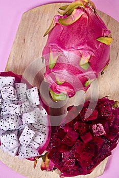 Red dragon fruit Set with appetizing serving on pink background. Top view