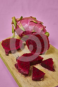 Red dragon fruit Set with appetizing serving on pink background. Top view