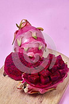 Red dragon fruit Set with appetizing serving on pink background. Top view