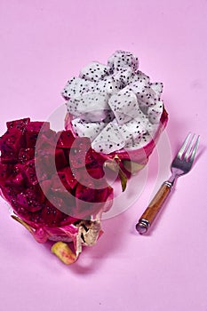 Red dragon fruit Set with appetizing serving on pink background. Top view