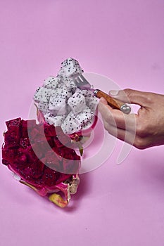 Red dragon fruit Set with appetizing serving on pink background. Top view