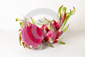 Red dragon fruit on white wooden background