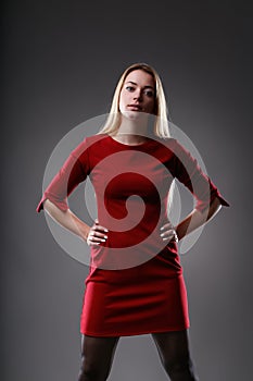 Red dress amplifies her commanding posture