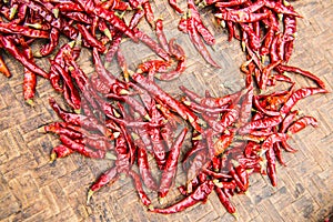 Red dried chilli on threshing basket